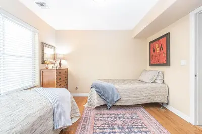 a bedroom with two beds and a window at Affordable 2Br Oceanfront W Large Patio, Boardwalk Access By Beachview Rentals in Newport Beach