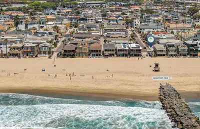 an aerial view of a beach with a group of people at 3Br W Oceanview Patio, 1 House From Popular 40Th St Beach By Beachview Rentals in Newport Beach