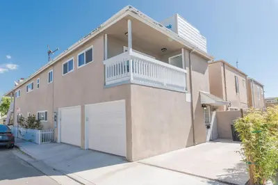 a brown house with a white garage at Updated 3Br W Oceanview Rooftop Deck, Steps To The Beach By Beachview Rentals in Newport Beach
