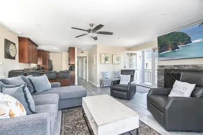 a living room with a couch and a fireplace at Updated 3Br W Oceanview Rooftop Deck, Steps To The Beach By Beachview Rentals in Newport Beach