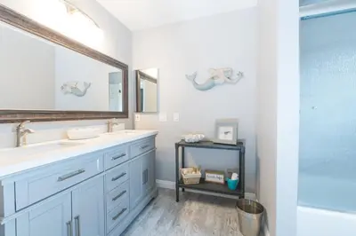 a bathroom with two sinks and a mirror at Updated 3Br W Oceanview Rooftop Deck, Steps To The Beach By Beachview Rentals in Newport Beach