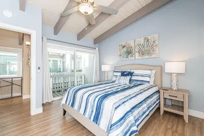 a bedroom with a bed and a ceiling fan at Charming 2Br Condo W Ac, Steps To Beach And Balboa Pier By Beachview Rentals in Newport Beach