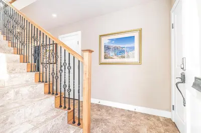 a staircase in a home with a picture on the wall at Charming 2Br Condo W Ac, Steps To Beach And Balboa Pier By Beachview Rentals in Newport Beach