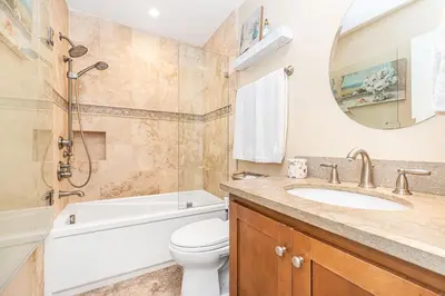 a bathroom with a sink and a toilet and a bathtub at Charming 2Br Condo W Ac, Steps To Beach And Balboa Pier By Beachview Rentals in Newport Beach
