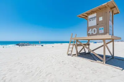 a lifeguard station on a beach with the ocean at Spacious 4Br W Ocean Views And 2 Balconies, Steps To Sand By Beachview Rentals in Newport Beach