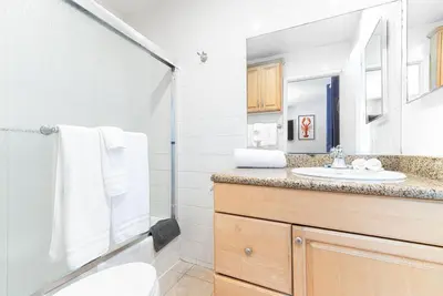 a bathroom with a toilet sink and a shower at Spacious 4Br W Ocean Views And 2 Balconies, Steps To Sand By Beachview Rentals in Newport Beach