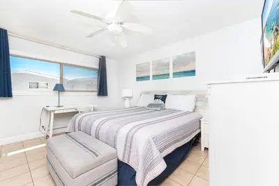 a bedroom with a bed and a ceiling fan at Spacious 4Br W Ocean Views And 2 Balconies, Steps To Sand By Beachview Rentals in Newport Beach