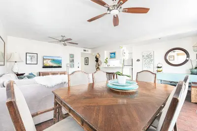 a dining room with a table and a living room at Affordable 2Br, Central Location, Walk To Beach And Dining By Beachview Rentals in Newport Beach