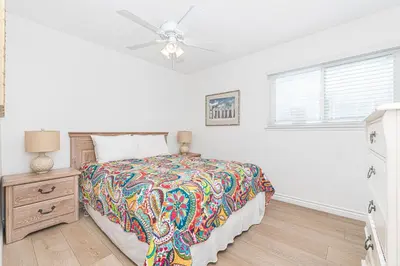 a bedroom with a bed and a ceiling fan at 7Br Duplex W Oceanview Balcony And Ac, Walk To It All By Beachview Rentals in Newport Beach