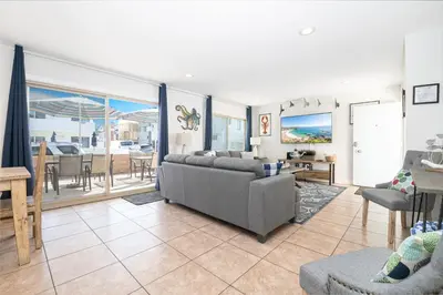a living room with a couch and chairs and a table at 3Br W Spacious Oceanview Patio, Only One House From Sand By Beachview Rentals in Newport Beach