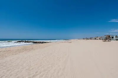 a sandy beach with the ocean in the background at Remodeled 2Br Oceanfront W Spacious Patio, Stunning Views By Beachview Rentals in Newport Beach