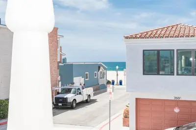 a white truck parked in front of a house at Steps To Sand! 7Br Retreat W Ocean Views In Prime Location By Beachview Rentals in Newport Beach