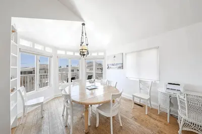 a white dining room with a table and chairs at 2Br Beach Escape W Oceanview Deck, 2 Houses From The Sand By Beachview Rentals in Newport Beach