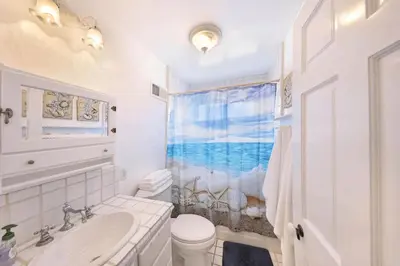 a white bathroom with a sink and a toilet at 2Br Beach Escape W Oceanview Deck, 2 Houses From The Sand By Beachview Rentals in Newport Beach