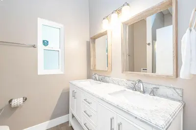 a bathroom with a sink and a mirror at Stylish 6Br Duplex, One Block From Beach And Boardwalk By Beachview Rentals in Newport Beach