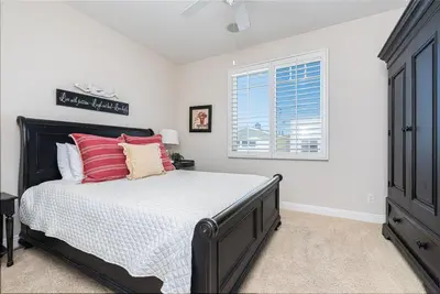 a bedroom with a bed and a window at Darling 3Br Beach Home On Quiet Street, Easy Walk To Beach By Beachview Rentals in Newport Beach