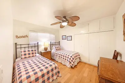 a bedroom with two beds and a ceiling fan at Charming 4Br W Large Garden Patio, 2 Houses From The Sand By Beachview Rentals in Newport Beach