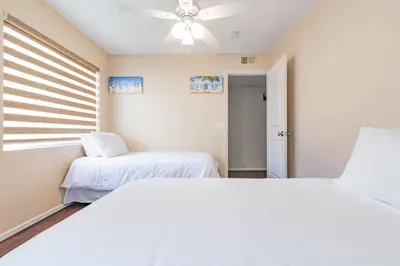 a bedroom with two beds and a ceiling fan at 3Br Oceanfront At Balboa Pier, Ac, Walk To It All By Beachview Rentals in Newport Beach