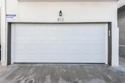 a white garage door with a number on it at 3Br Oceanfront At Balboa Pier, Ac, Walk To It All By Beachview Rentals in Newport Beach