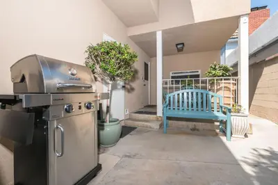 a grill and a blue bench on a patio at Spacious 3Br Bayfront W Harbor Views, Walk To Beach By Beachview Rentals in Newport Beach