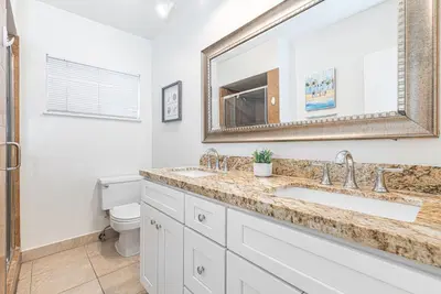 a bathroom with a sink and a mirror at Charming 3Br W Large Deck, Walk To Beach And Marina Park By Beachview Rentals in Newport Beach