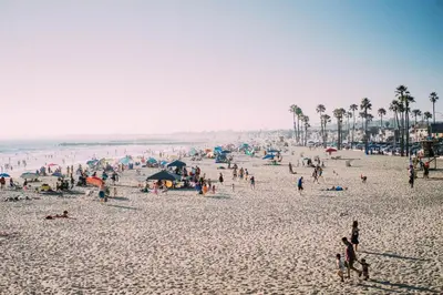 a large group of people on a beach at 5Br Coastal Retreat W Ocean Views - Steps From Beach By Beachview Rentals in Newport Beach