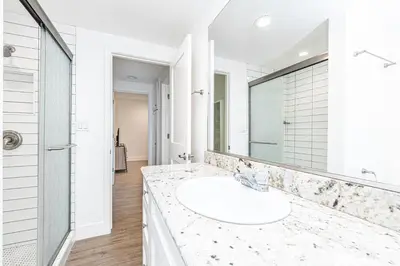 a white bathroom with a sink and a mirror at Updated 2Br Cottage One House From Beach - Super Central By Beachview Rentals in Newport Beach