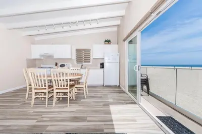 a kitchen and dining room with a table and chairs at 8Br Coastal Getaway W Gorgeous Views At An Excellent Value By Beachview Rentals in Newport Beach