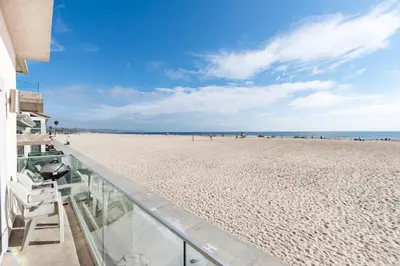 a view of the beach from the balcony of a beach house at 8Br Coastal Getaway W Gorgeous Views At An Excellent Value By Beachview Rentals in Newport Beach