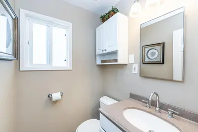 a bathroom with a sink and a toilet and a mirror at 8Br Coastal Getaway W Gorgeous Views At An Excellent Value By Beachview Rentals in Newport Beach