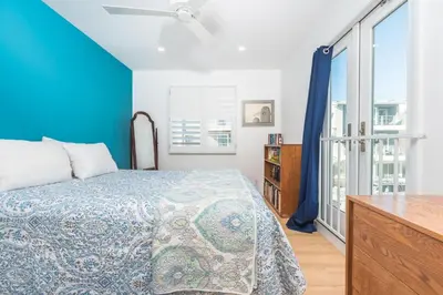 a bedroom with a bed and a blue wall at Renovated 3Br Oceanfront W Panoramic Views By Beachview Rentals in Newport Beach