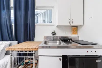 a small kitchen with a sink and a counter at Affordable Studio, Steps From Beach And Marina Park By Beachview Rentals in Newport Beach