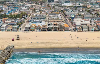an aerial view of a beach with a crowd of people at Roomy 2Br W Large Patio, Fire Pit And Ocean Views By Beachview Rentals in Newport Beach