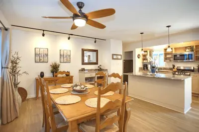 a dining room and kitchen with a table and a ceiling fan at Quiet 1Br Bayside Apartment, Central, Steps To Baybeach By Beachview Rentals in Newport Beach
