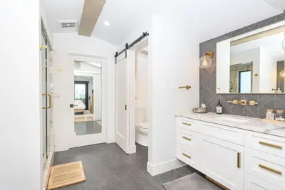a bathroom with a sink and a toilet at Luxe 3Br Near The Sand W Rooftop Spa, Ocean Views, And Ac By Beachview Rentals in Newport Beach