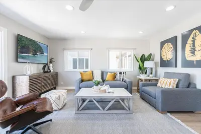 a living room with a couch and a table at Remodeled 2Br, One House From Beach, Walk To Shopsdining By Beachview Rentals in Newport Beach