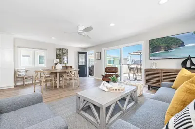 a living room with a couch and a table at Remodeled 2Br, One House From Beach, Walk To Shopsdining By Beachview Rentals in Newport Beach