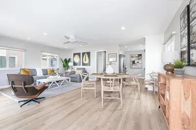 a kitchen and living room with a table and chairs at Remodeled 2Br, One House From Beach, Walk To Shopsdining By Beachview Rentals in Newport Beach