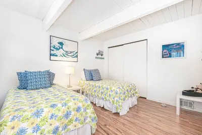 a bedroom with two beds and a window at Serene 3Br Bayside Home, Private Waterfront Dock And Patio By Beachview Rentals in Newport Beach