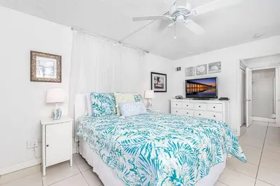 a bedroom with a bed and a ceiling fan at Serene 3Br Bayside Home, Private Waterfront Dock And Patio By Beachview Rentals in Newport Beach