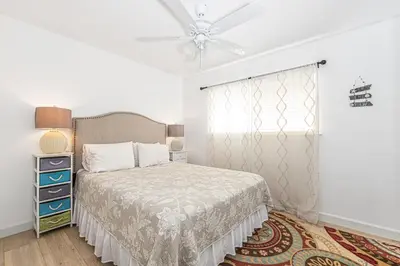 a bedroom with a bed and a ceiling fan at Epic 7Br Retreat W Oceanview Rooftop Deck - Steps To Sand By Beachview Rentals in Newport Beach