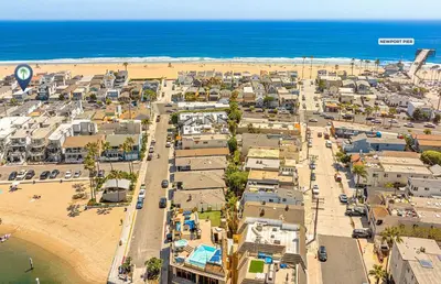 an aerial view of a city next to the beach at Cozy And Central 3Br, Steps From Sand And Marina Park By Beachview Rentals in Newport Beach