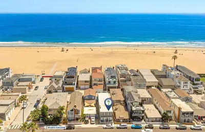 an aerial view of a beach with houses and the ocean at Spacious 7Br Triplex Steps From Beach And Marina Park By Beachview Rentals in Newport Beach