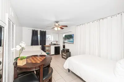 a bedroom with two beds and a table with a chessboard at Spacious 7Br Triplex Steps From Beach And Marina Park By Beachview Rentals in Newport Beach