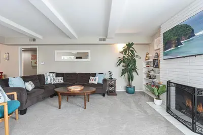 a living room with a couch and a fireplace at Peaceful Lido Island 3Br, Walk To Bay, Beach And Shopping By Beachview Rentals in Newport Beach