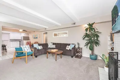 a living room with a couch and a table at Peaceful Lido Island 3Br, Walk To Bay, Beach And Shopping By Beachview Rentals in Newport Beach