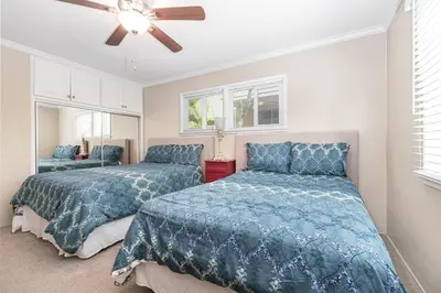 a bedroom with two beds and a ceiling fan at Peaceful Lido Island 3Br, Walk To Bay, Beach And Shopping By Beachview Rentals in Newport Beach