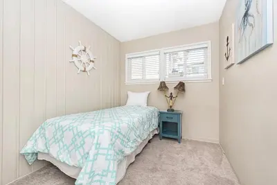 a small bedroom with a bed and a window at Peaceful Lido Island 3Br, Walk To Bay, Beach And Shopping By Beachview Rentals in Newport Beach
