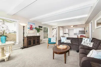 a living room with a couch and a table at Peaceful Lido Island 3Br, Walk To Bay, Beach And Shopping By Beachview Rentals in Newport Beach