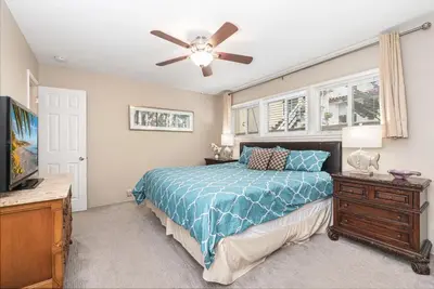 a bedroom with a bed and a ceiling fan at Peaceful Lido Island 3Br, Walk To Bay, Beach And Shopping By Beachview Rentals in Newport Beach